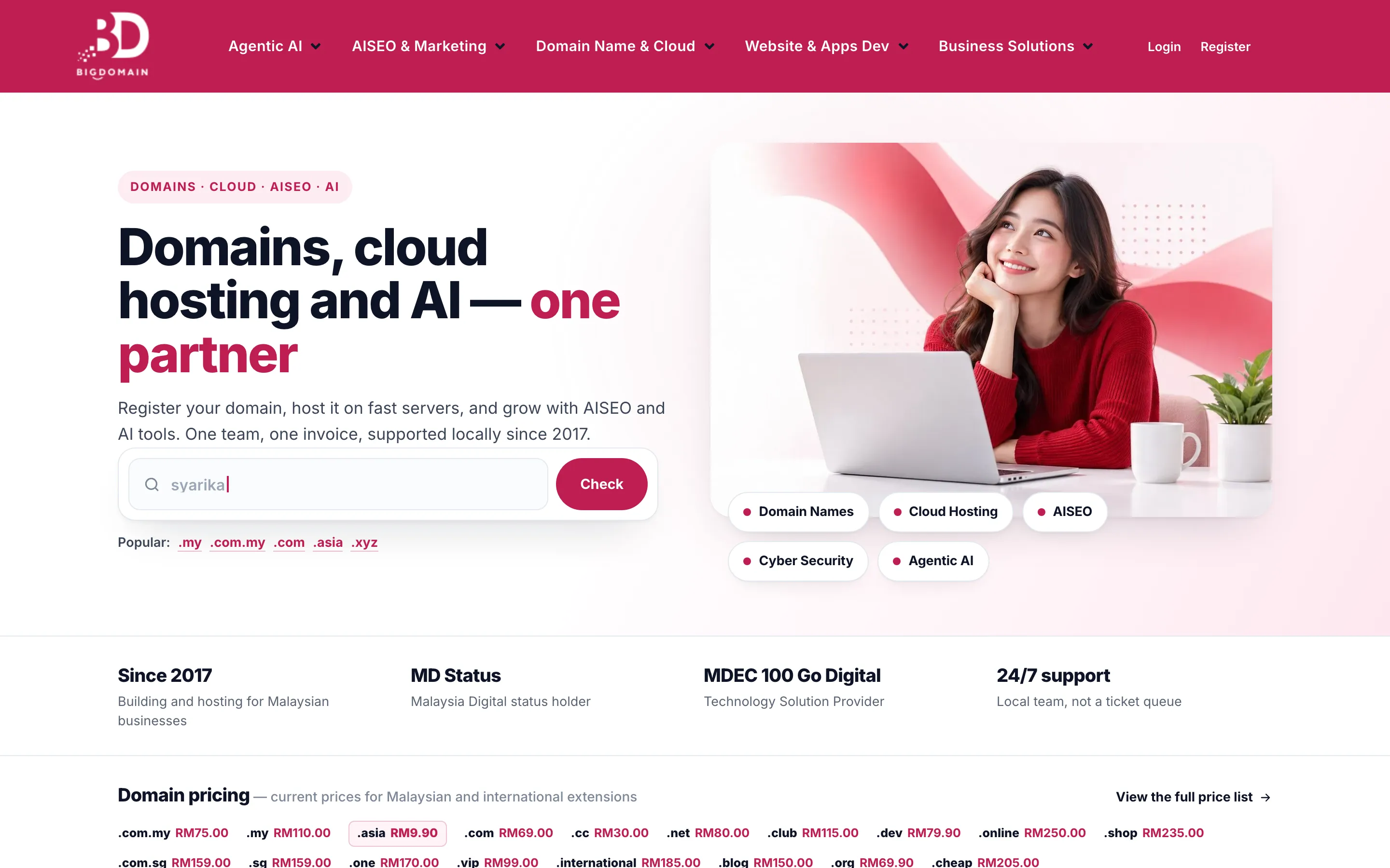 Big Domain’s home page, with a headline about domains, cloud hosting and AI beside a photo of a woman at a laptop, a domain search bar and a row of domain prices