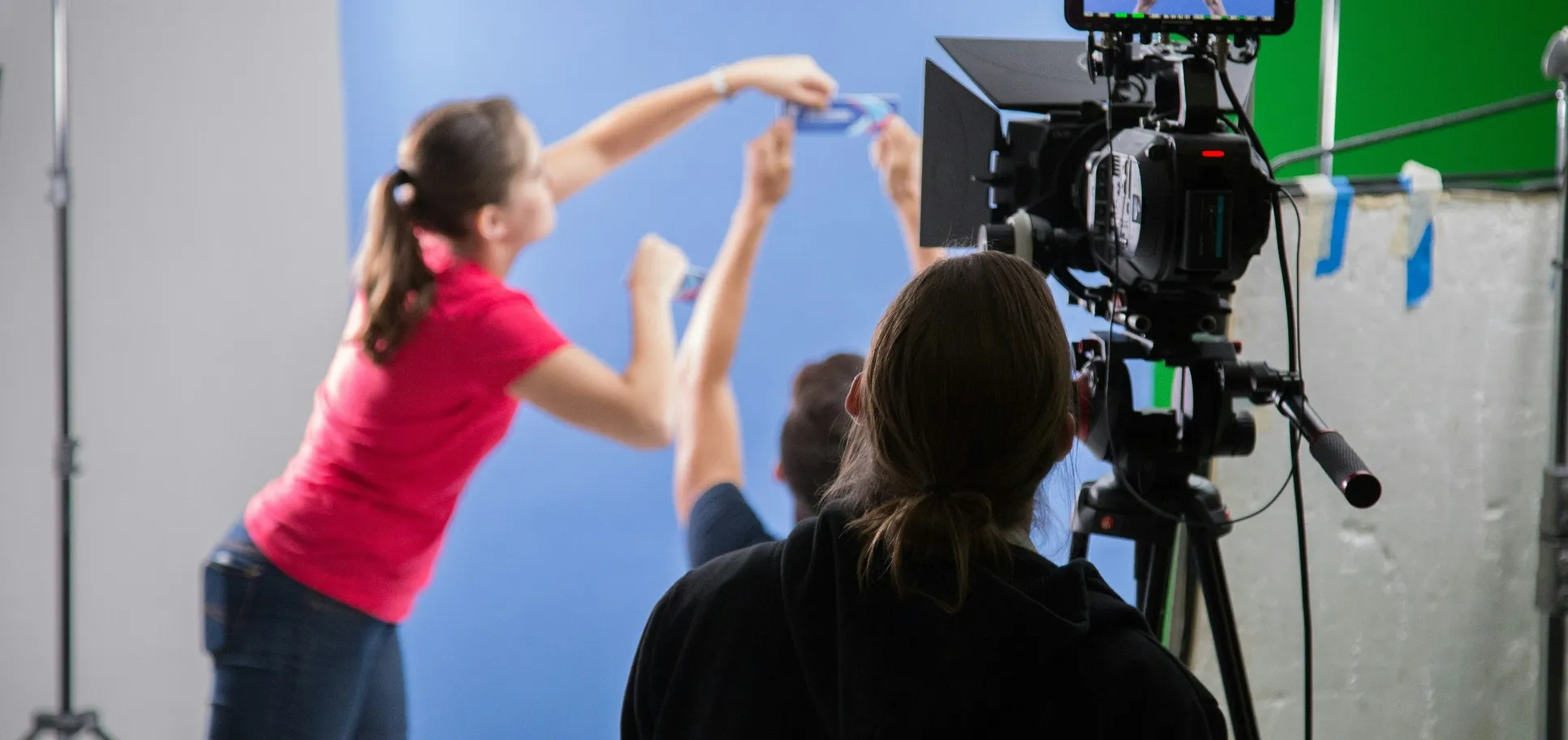 A Primal crew setting up a blue screen on a video shoot