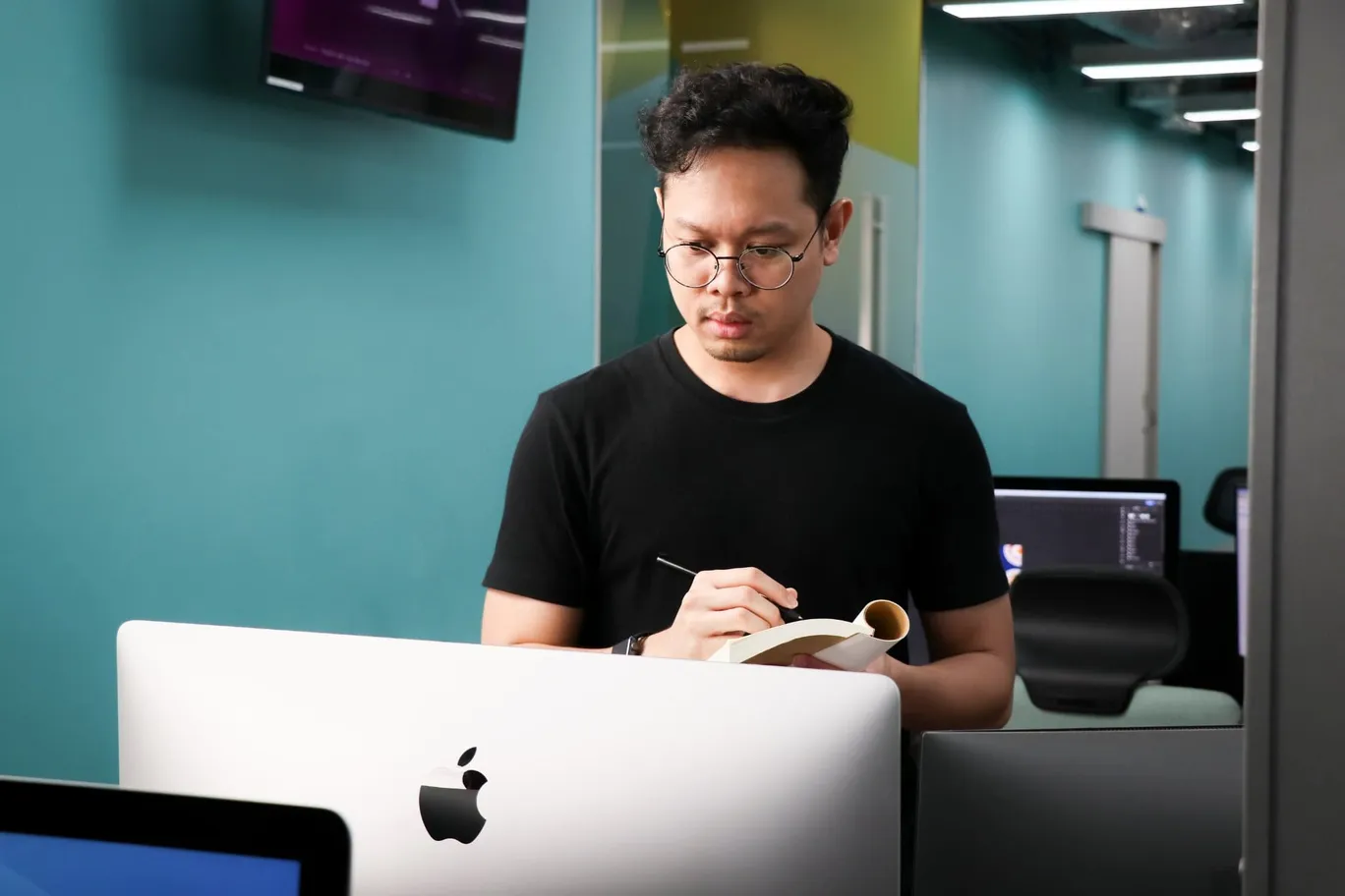 A Primal team member making notes at his desk