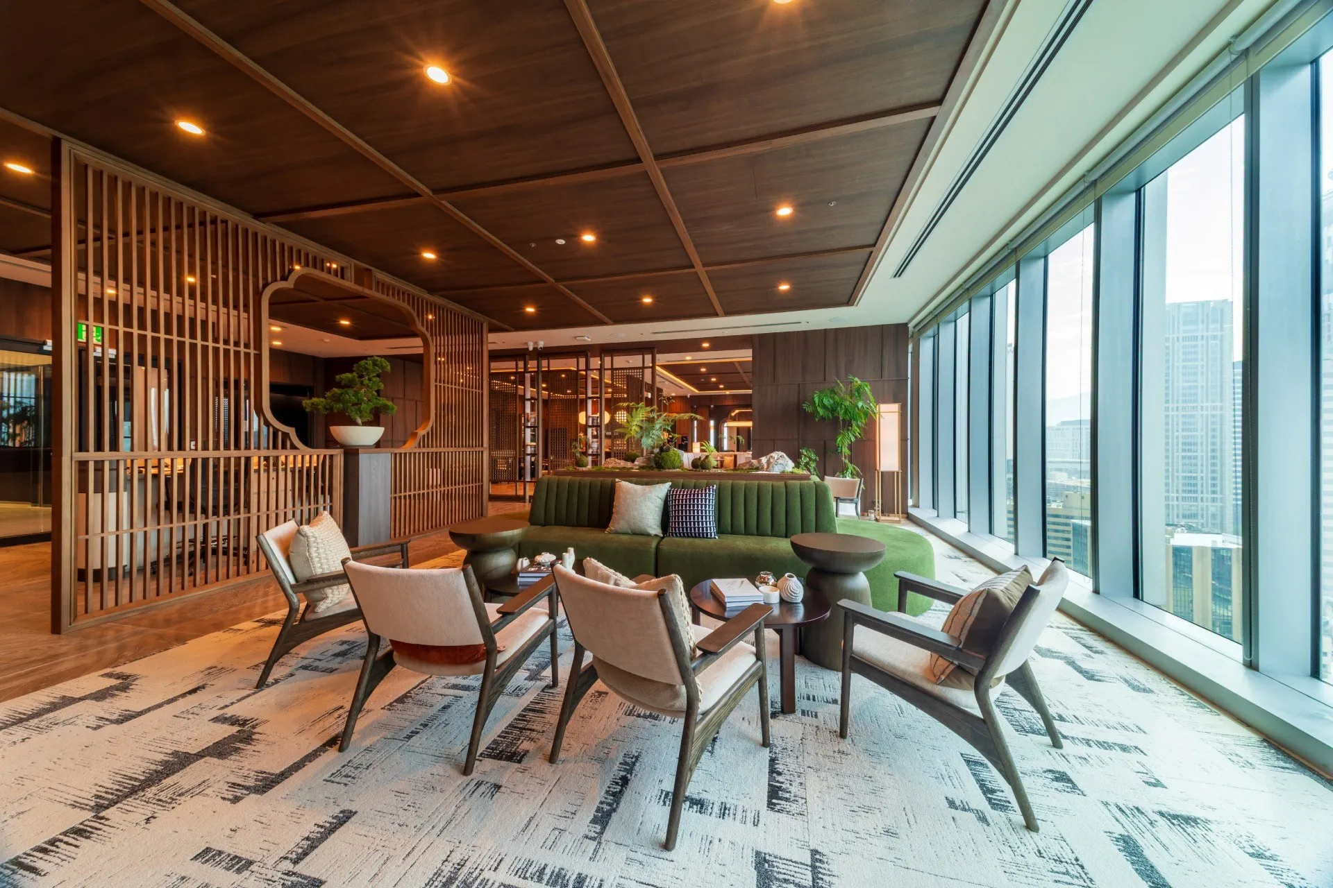 A JustCo coworking lounge with armchairs and wood panelling