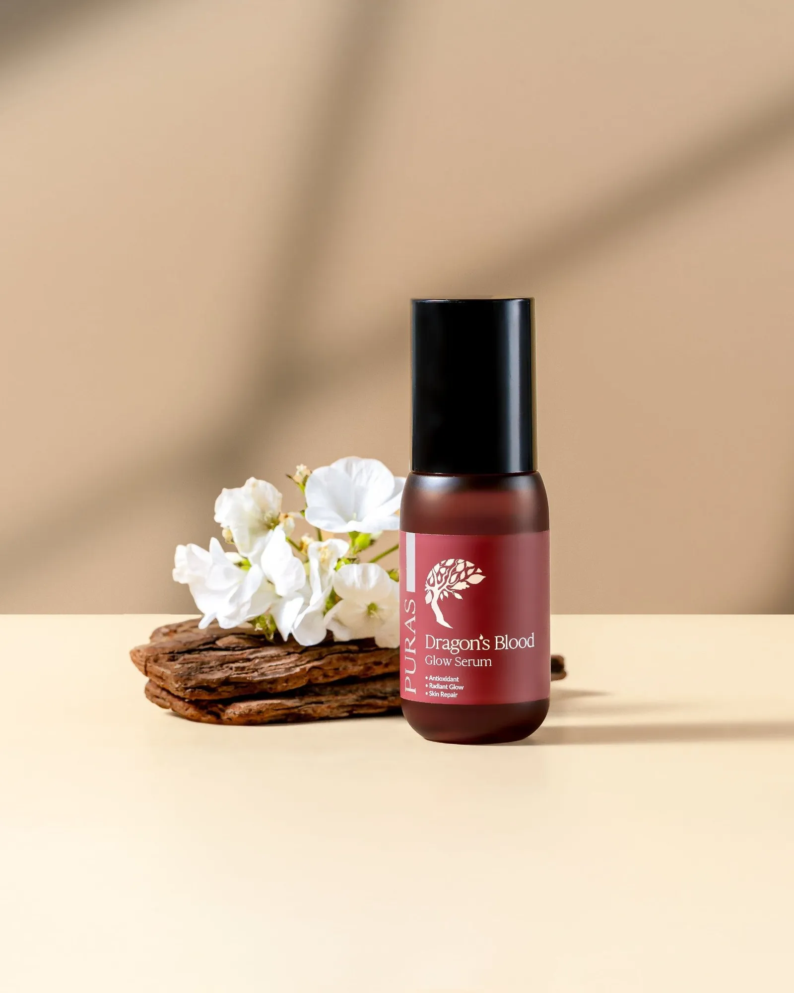 A PURAS serum bottle on wood with white flowers