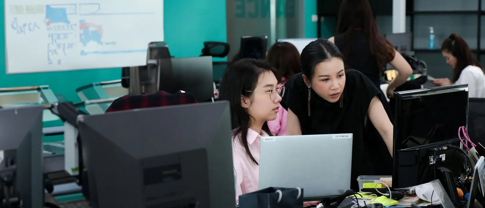Primal colleagues working together at their screens in the office