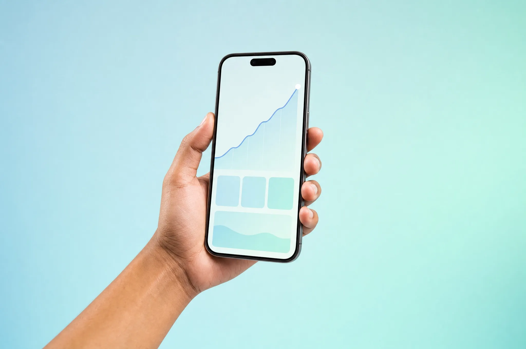 A hand holding a phone with a rising chart