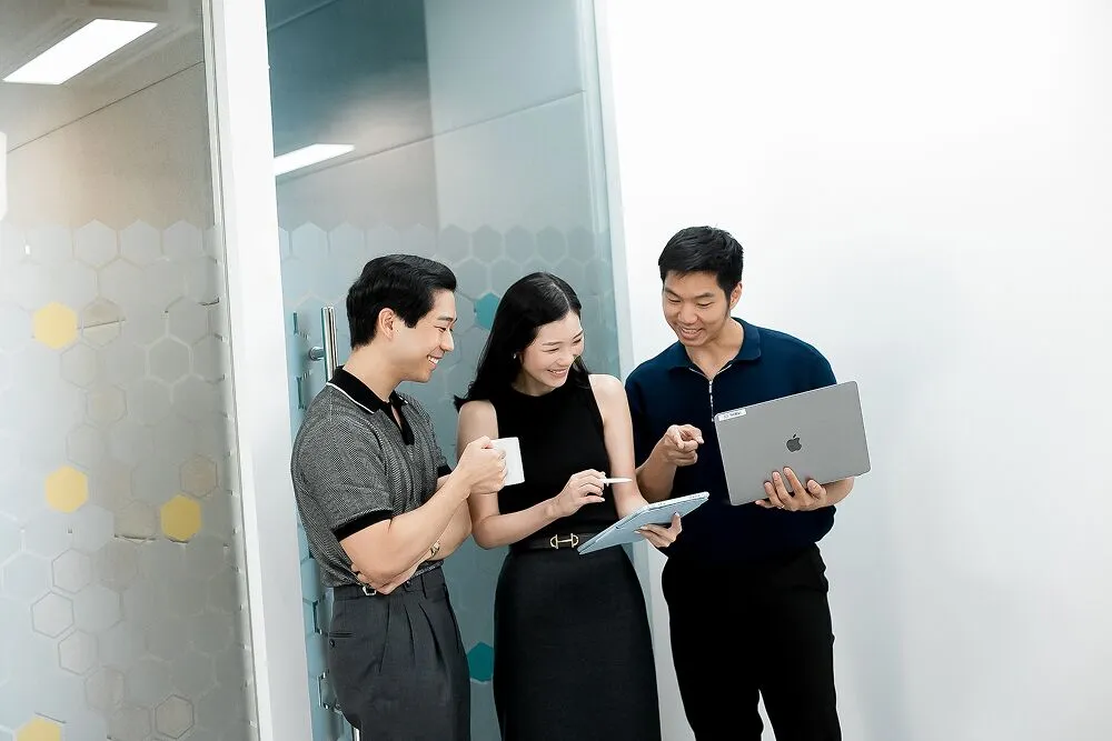 Three Primal colleagues looking at a tablet together