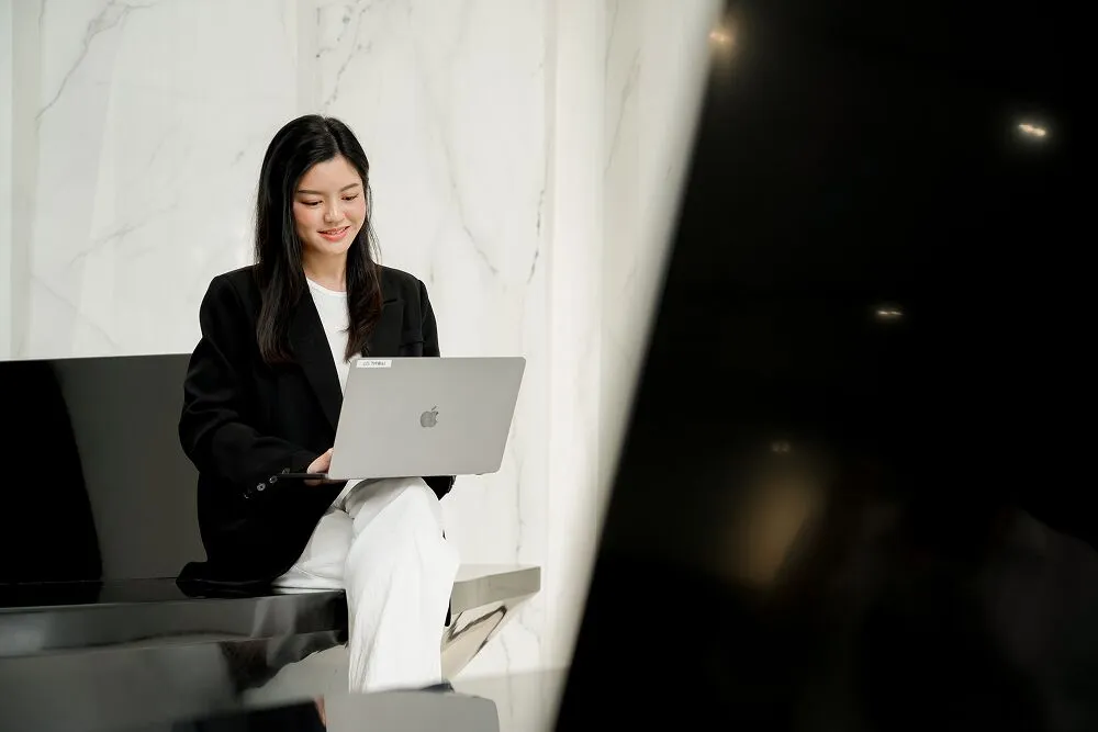 A Primal team member working on a laptop in the office