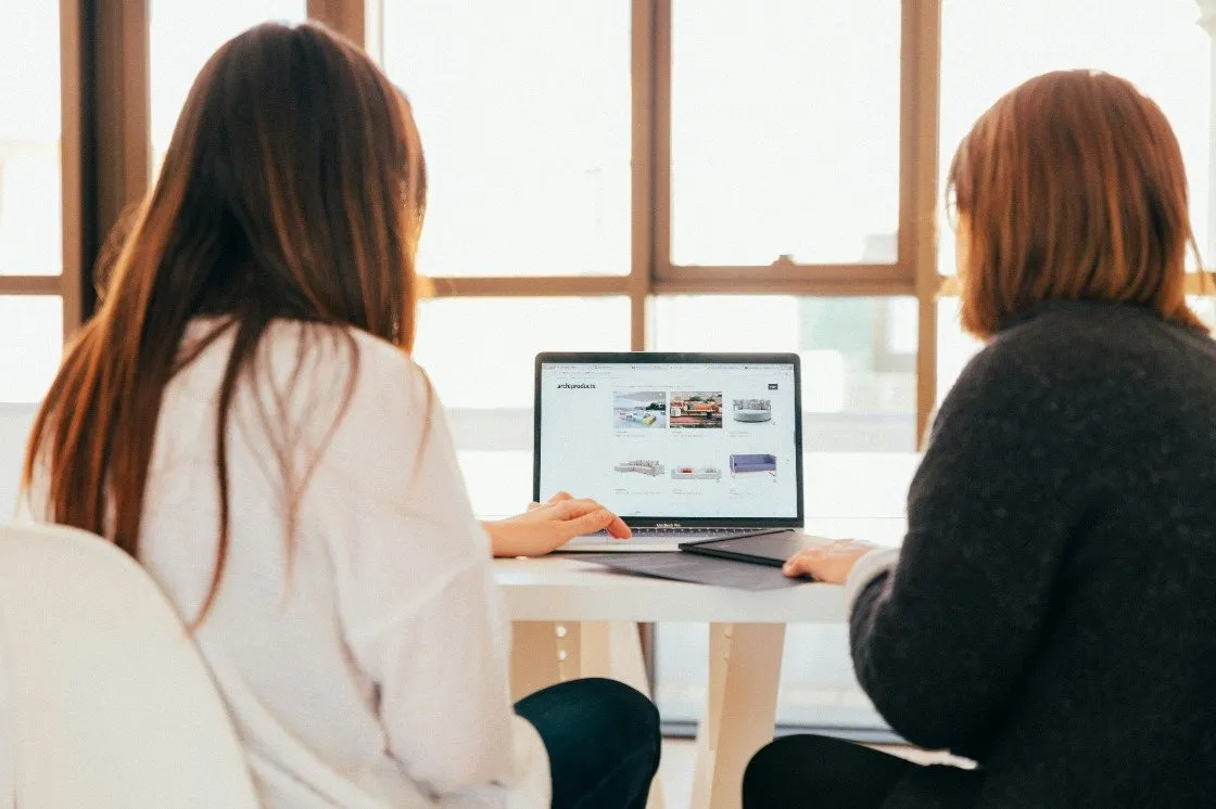 Two Primal colleagues looking at an online store on a laptop