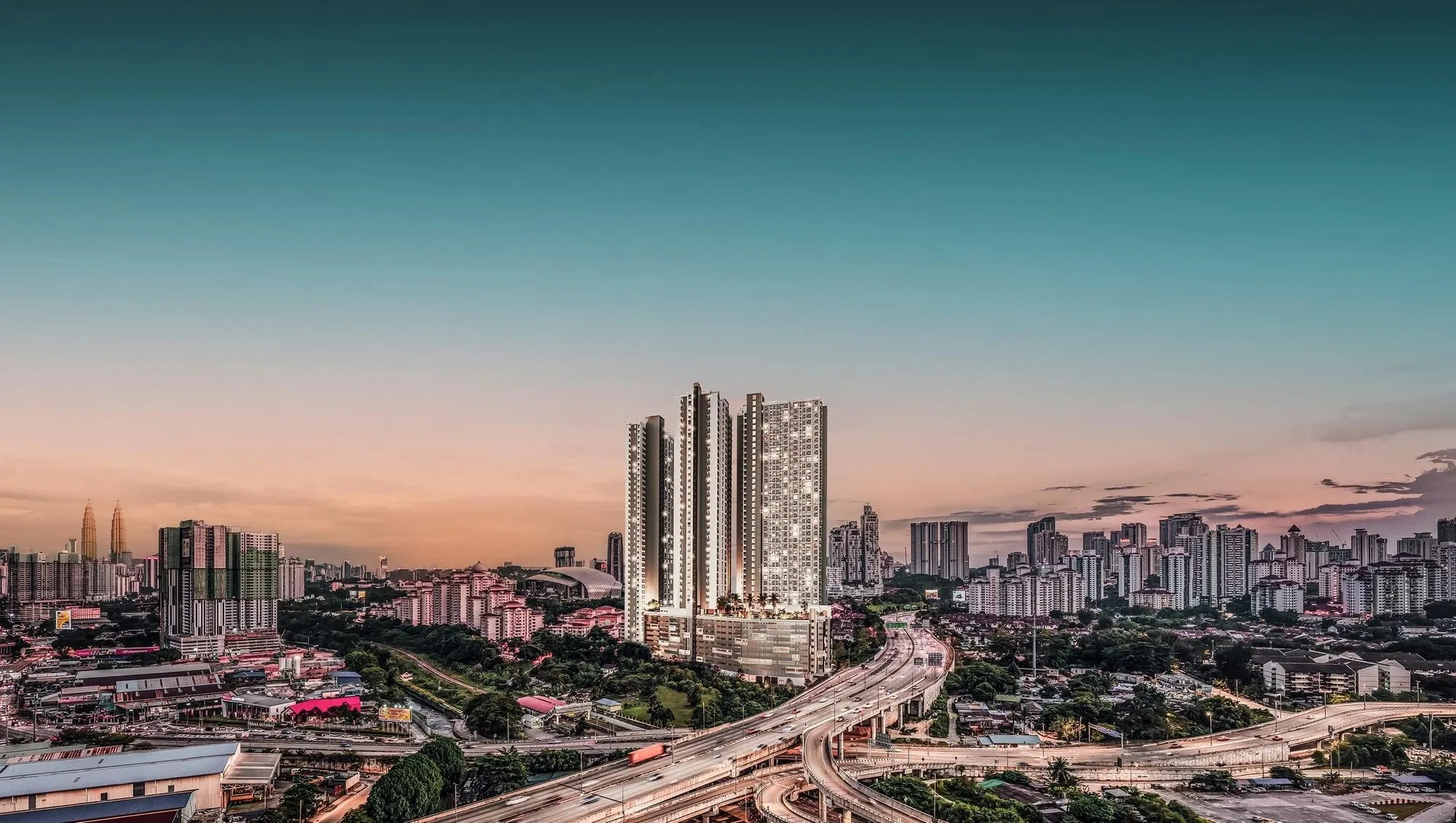 The YNH Solasta Dutamas tower at dusk above the highway