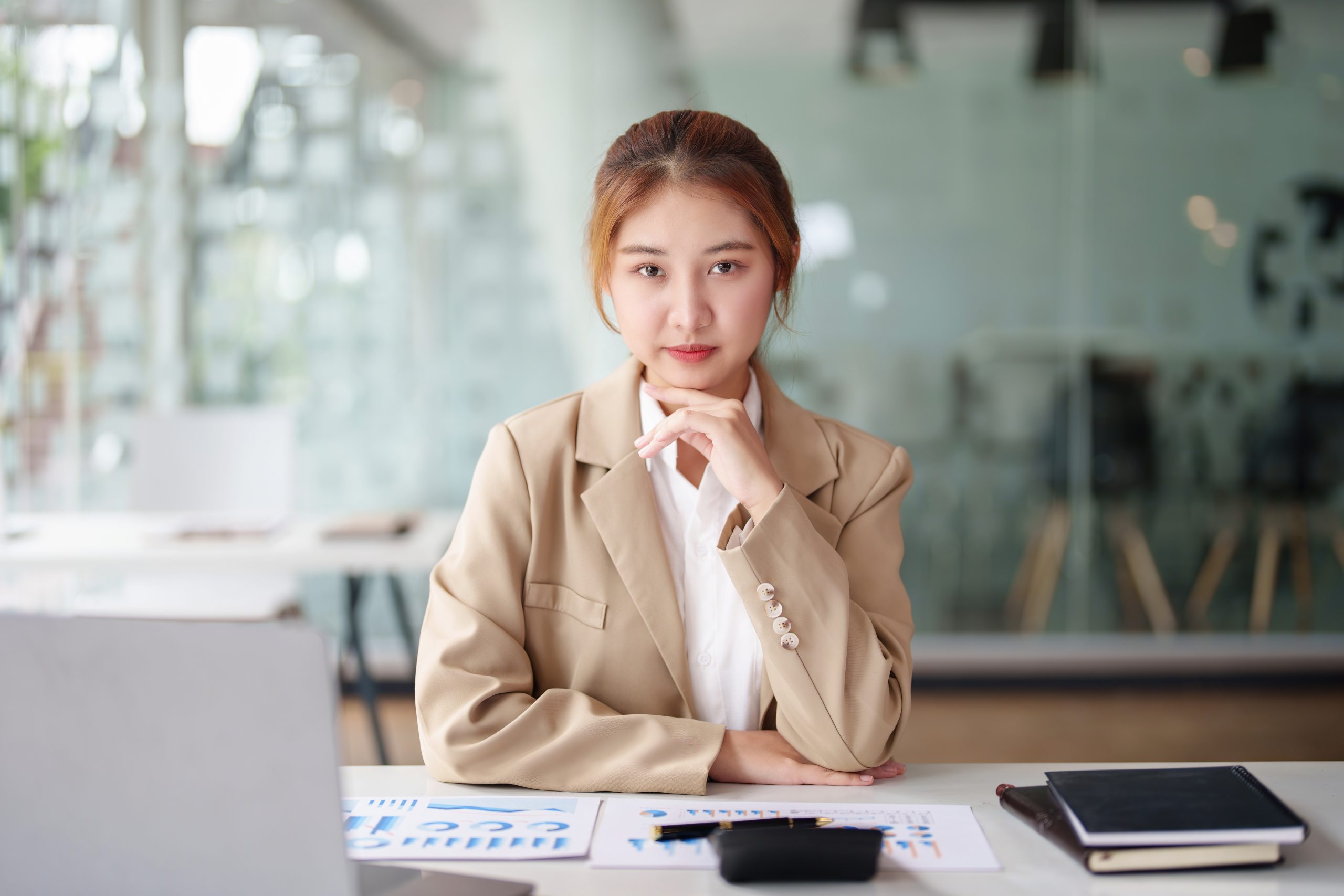 A marketing manager reviewing her website’s AI search readiness metrics, looking uncertain of it.