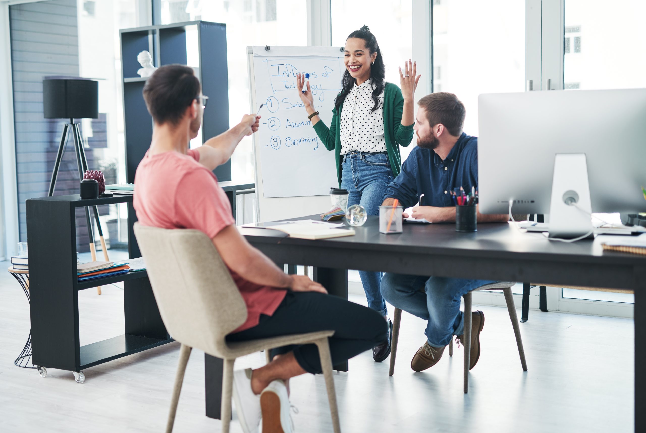 A social media marketing team discusses how to stay on top of the latest trends.